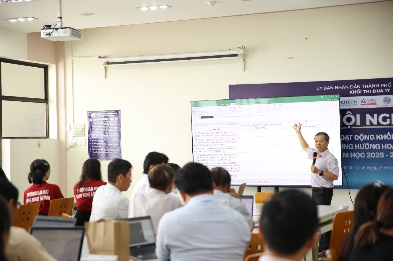 A person standing in front of a large screenAI-generated content may be incorrect.